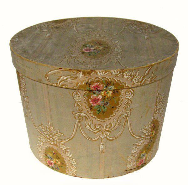 Decorated hat box with paper in a floral and swag desig: Decorated hat box with paper in a floral and swag design, includes three vintage hats. Some wear to edges and fading. Appropriate age wear. $70-100
