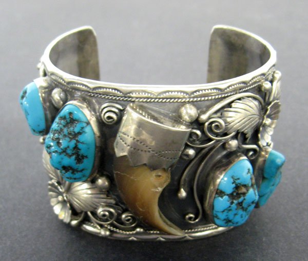 Pawn sterling silver cuff bracelet with bear paw and tu: Pawn sterling silver cuff bracelet with bear paw and turquoise colored stones, signed F.J.[?]. tight hairline and hole in bear claw. Appropriate age wear. $300-500