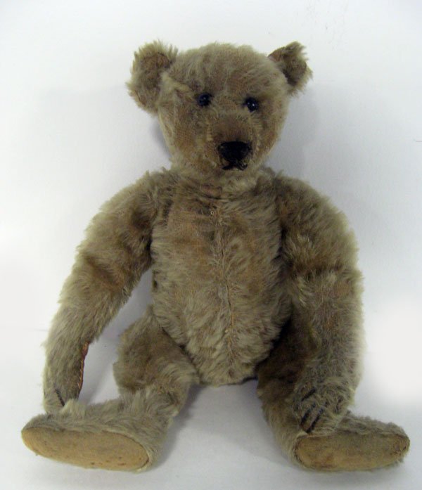 Antique 12'' Steiff bear. Ca 1910. German, blonde mohai: Antique 12'' Steiff bear. Ca 1910. German, blonde mohair, jointed, elongated limbs, hump on back, Four stitched claws on paws and feet. Shoe button eyes 1 original and 1 newer. No ID. Elongated nose p