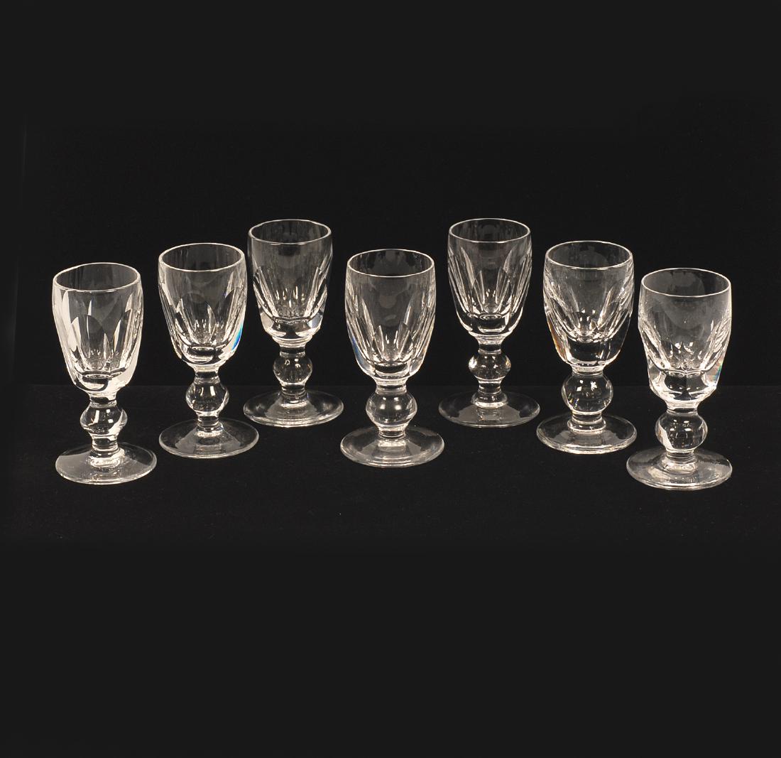 A set of Waterford crystal liqueur glasses: A set of seven cut lead glass (crystal) liqueur glasses, Waterford, Ireland, with faceted bowl and spreading foot. The undersides etched Waterford. Height 3 1/4 in.
