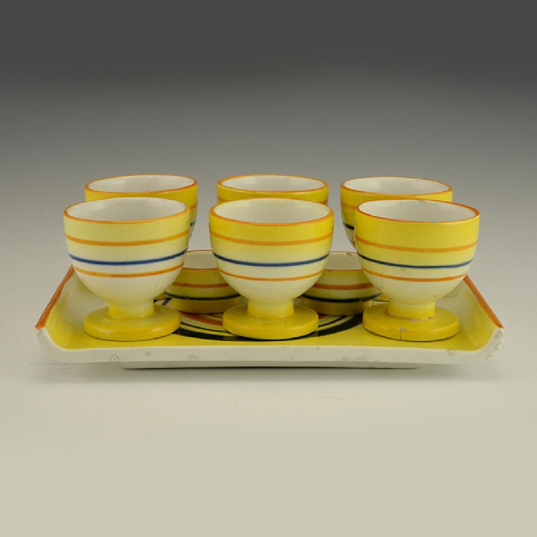 Eva Zeisel, a Schramberg Egg Set, ca1929-35: Eva Zeisel, an Egg Set comprising a Tray (model 3436), six Egg Cups (model 3419), and two Salters (model 3437) Schramberger Majolika-Fabrik, Schramberg, Germany, circa 1929-35. Décor 3465 (later nick