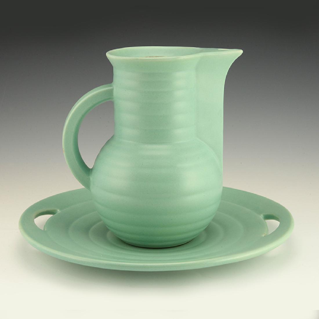 Eva Zeisel, a Schramberg Pitcher and Tray: Eva Zeisel, A Pitcher (model 3329) (lid is lacking) and Tray (model 3332), matte turquoise glaze. Height of Plate: 1 1/4 in. (3 cm); dia.: 10 3/4 in. (27.5 cm). Height of Pitcher: 7 1/4 in. (19 cm); l