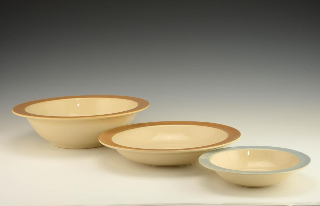 Eva Zeisel, Three Stratoware Bowls: Eva Zeisel with Francis E. Blod (1908-1979), a group of three Bowls from the Stratoware line, Universal Potteries, Cambridge, Ohio, 1942-1943. In Standard Sand body with Horizon Blue or Wing Brown rim