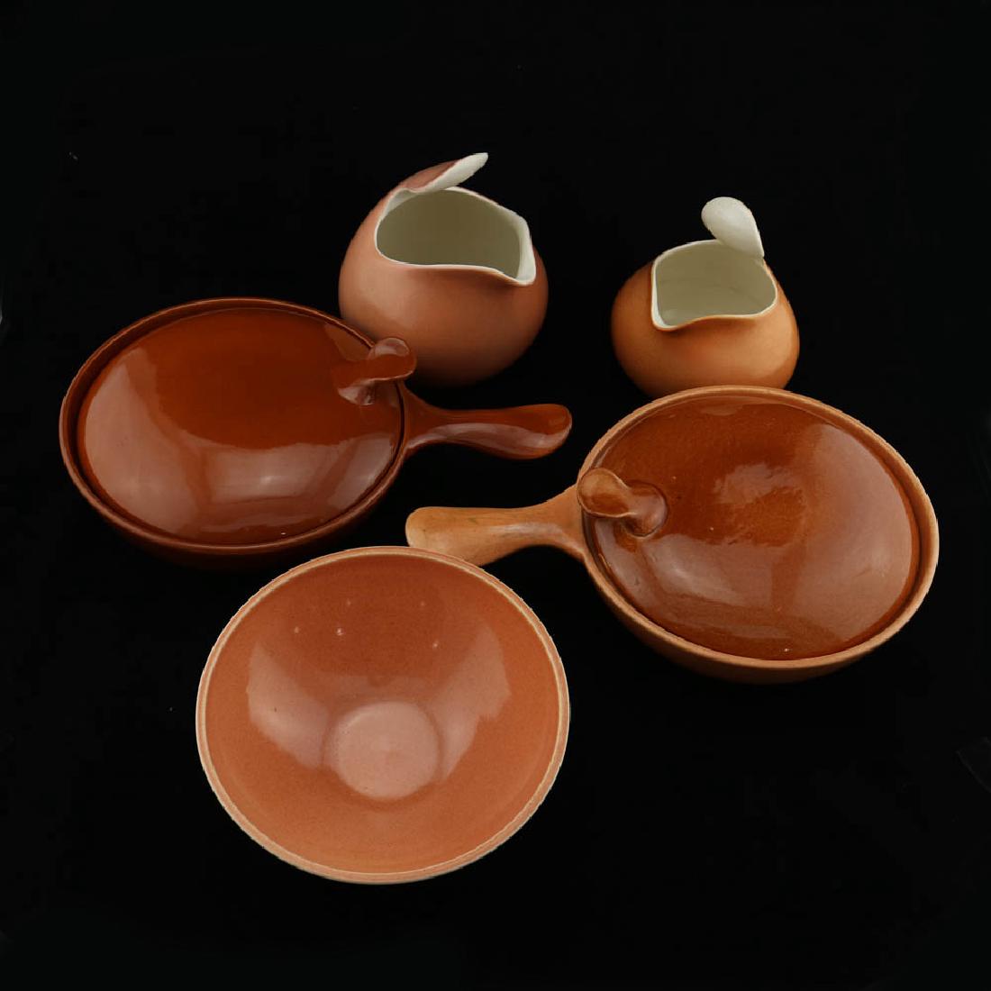 Eva Zeisel, Town & Country Serving Pieces: Eva Zeisel, a group of serving pieces comprising two covered Casseroles, a Salad Bowl (dia. 8 1/2 in.), a 2 Pint Pitcher, and a 3 Pint Pitcher, all in Peach or Rust glaze, Town and Country, Red Wing P