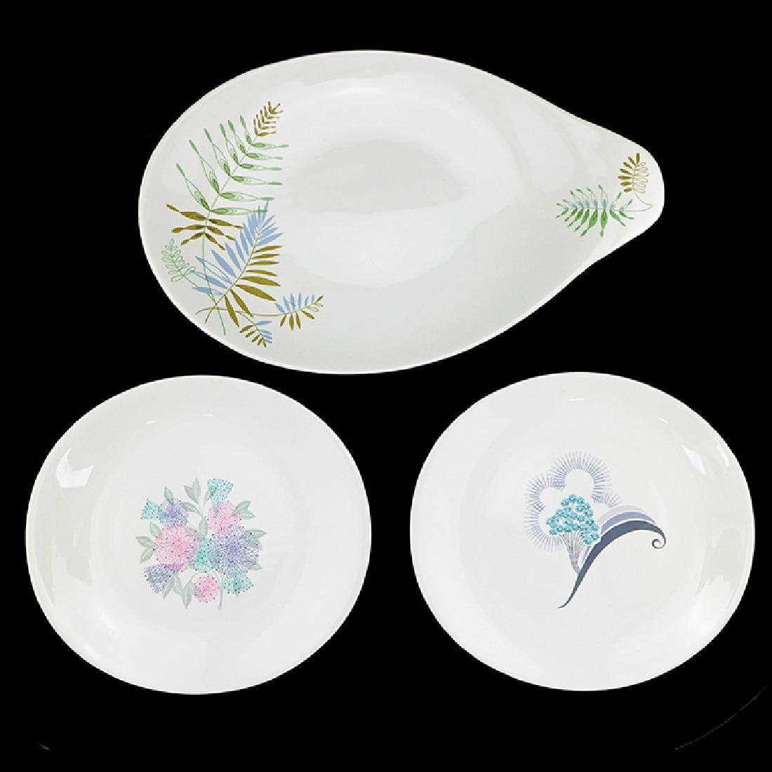 3 Zeisel Hallcraft Tomorrow's Classic Items: Eva Zeisel, a 17" Platter Covered Dish in Raintree, 1958, a Dinner Plate in Spring, after 1953, a Dinner Plate in Flair, 1956, the undersides with blue stamped Hallcraft Shape by Eva Zeisel or Hallcra