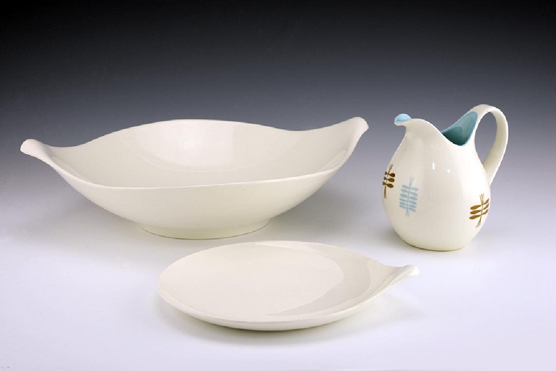3 Zeisel Hallcraft Century Items: Eva Zeisel, a Salad Bowl and a Bread Plate in White together with a Creamer in Flight, the undersides of the Bread Plate and Creamer stamped Eva Zeisel Century Hallcraft, the Salad Bowl unmarked, Hall
