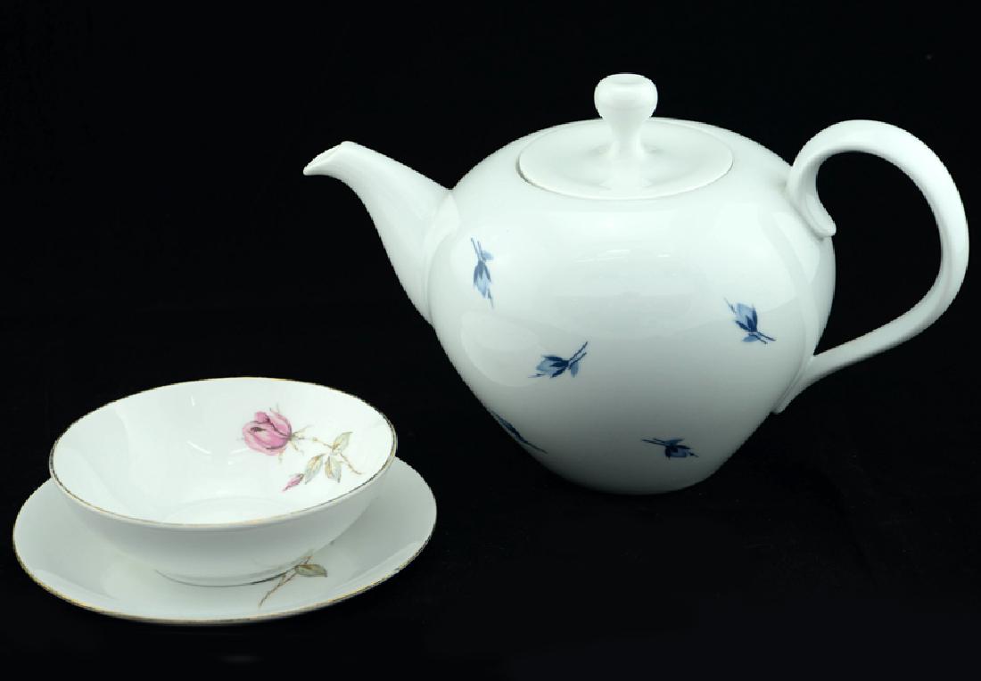 3 Zeisel Rosenthal Items: Eva Zeisel, a Fruit Bowl and Underplate from the Eva Line with Pink Rose decoration together with a Teapot with a Blue Rose decoration, Johann Haviland, Rosenthal AG, designed 1957-1958. Porcelain. Th