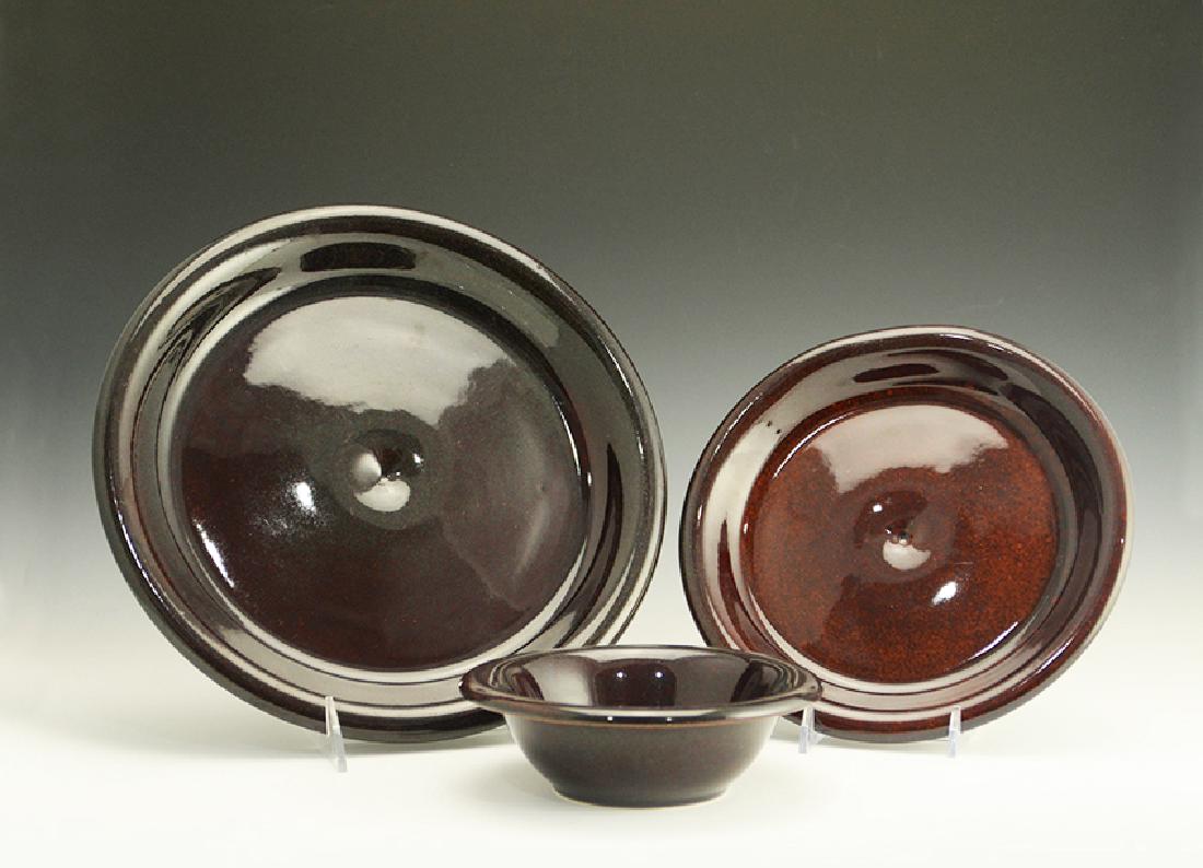 Rare Zeisel Hyalyn Oxblood Dining Items: Eva Zeisel, a group of rare dining pieces comprising a Dinner Plate, Salad Plate, and Bowl in Oxblood glaze, High Fashion, Hyalyn Porcelain, Hickory, NC, 1964. All with model numbers Z28, Z29, or Z34
