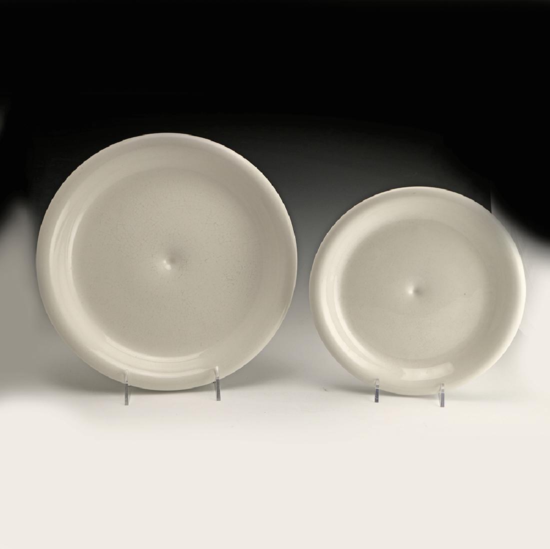 2 Rare Zeisel Hyalyn Plates: Eva Zeisel, an extremely rare Dinner Plate and Salad Plate in clear glaze, High Fashion, Hyalyn Porcelain, Hickory, NC, 1964. Porcelain. The underside of the Dinner Plate saucer with model number Z 28