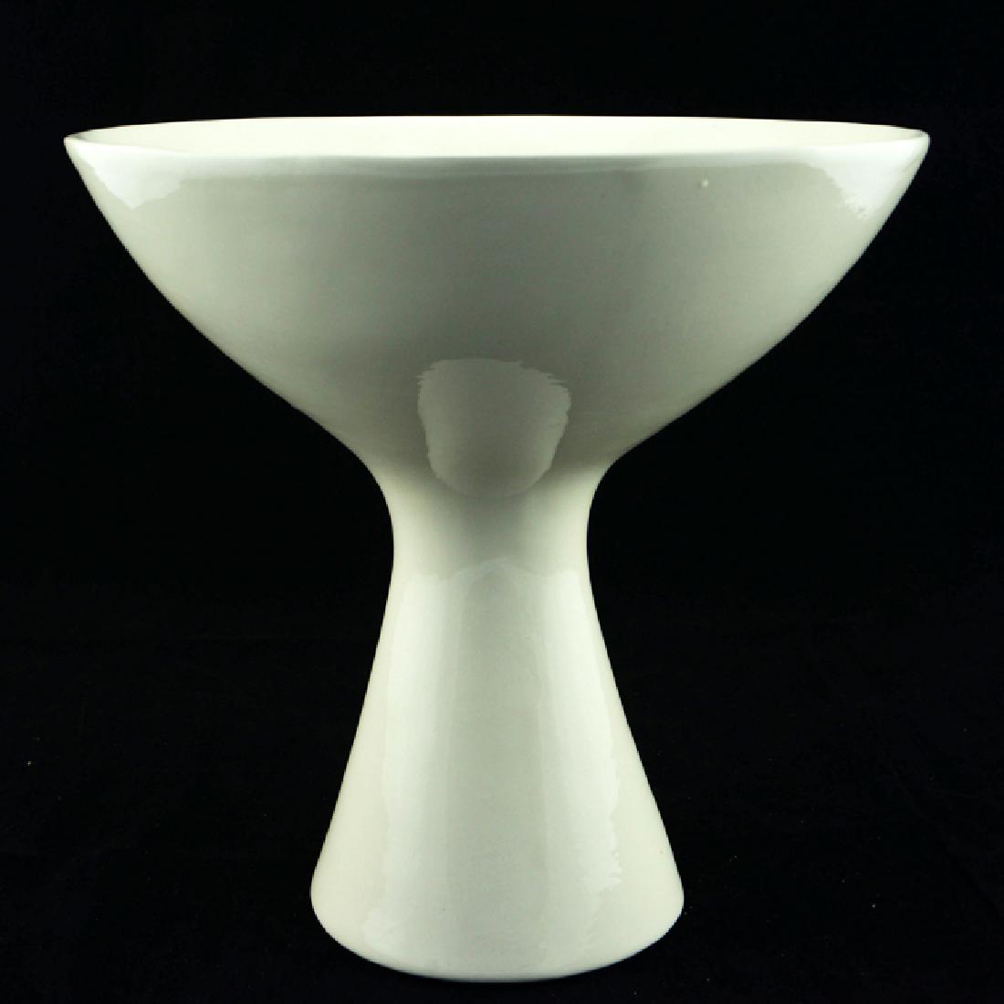 Zeisel OC Tazza Fruit Bowl (1997): Eva Zeisel, a Tazza-form Fruit Bowl with cream glaze, the shape based on a 1958 design for Manifattura Mancioli, with obscured black mark, apparently World of Ceramics, Morganton, North Carolina, for