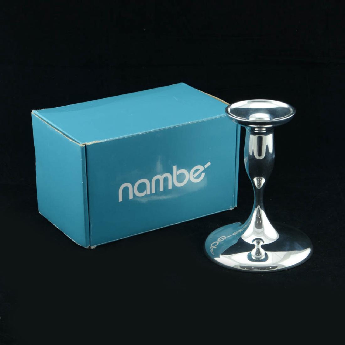 Zeisel Nambe Eden Candlestick (2008): Eva Zeisel, Eden candlestick, MT0011, Nambé, designed 2008, no longer in production. Nambe proprietary metal alloy. H. 6 ¼ in. (15.9 cm), diameter of base 4 3/4 in. (12 cm). 1620-309 On Zeisel’s c