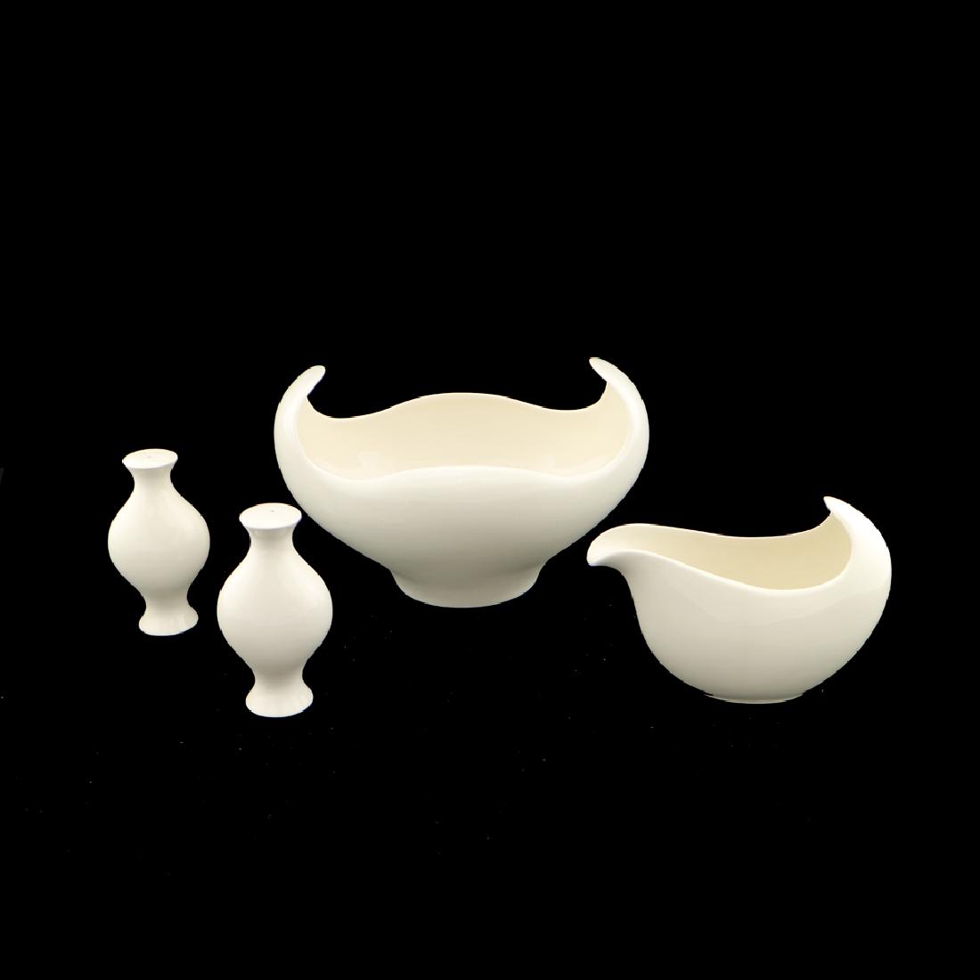 4 Zeisel One-O-One Line Serving Items (2006): Eva Zeisel, a group of serving and dining pieces comprising a Rocking Bowl, a Sauce Boat, and Salt and Pepper Shakers, One-O-One, Royal Stafford, Stoke-on-Trent, England, designed 2006, 2008. Earthenw
