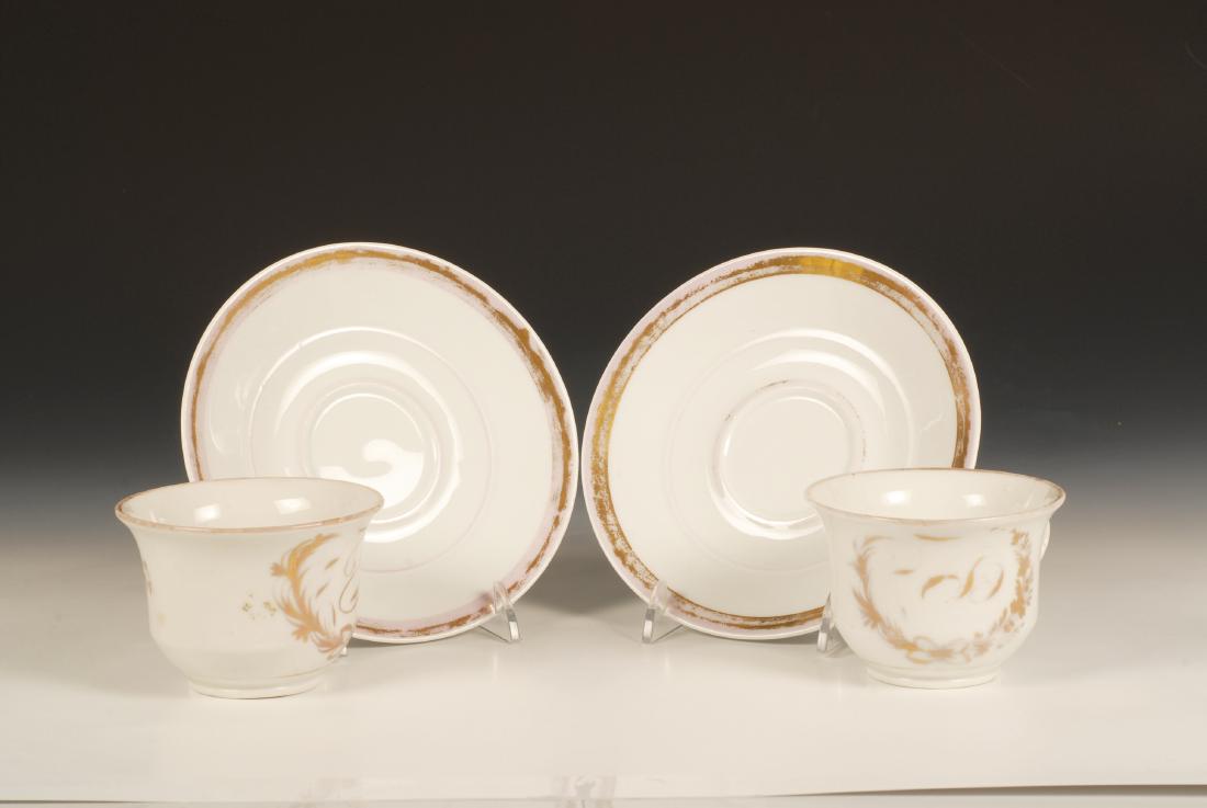 Gardner Cups & Saucers, Persian market: A pair of Russian porcelain cups and saucers for the Persian or Central Asian market, Gardner Factory, circa 1880. The cups and saucers with gilt edges and rims, each cup with a gilt initial surrounde