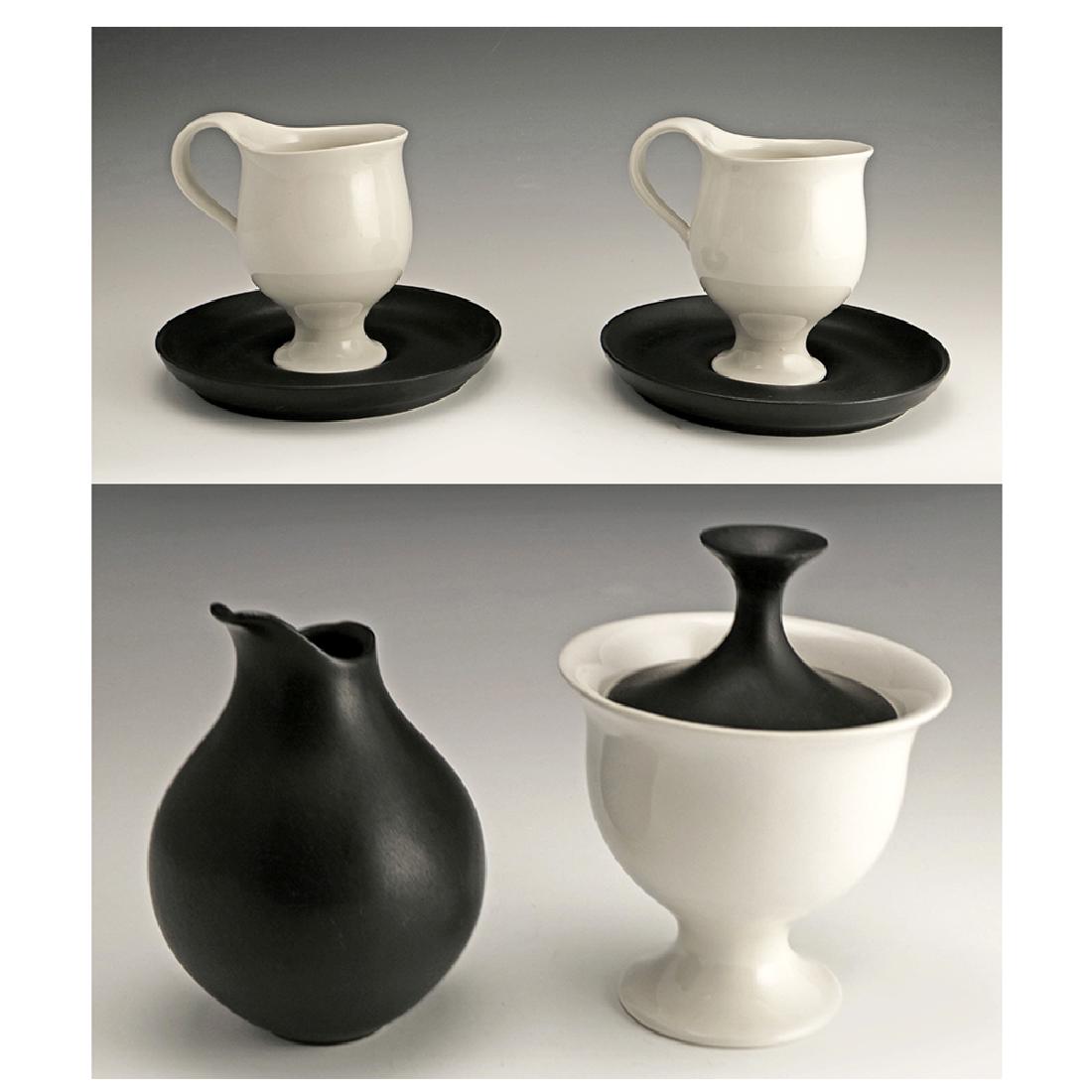 Very Rare Zeisel Hyalyn B&W Group: Eva Zeisel, an extremely rare group in clear and matte black glaze comprising a Covered Sugar, a Creamer, and pair of Cups and Saucers, High Fashion, Hyalyn Porcelain, Hickory, NC, 1964. Porcelain. Th
