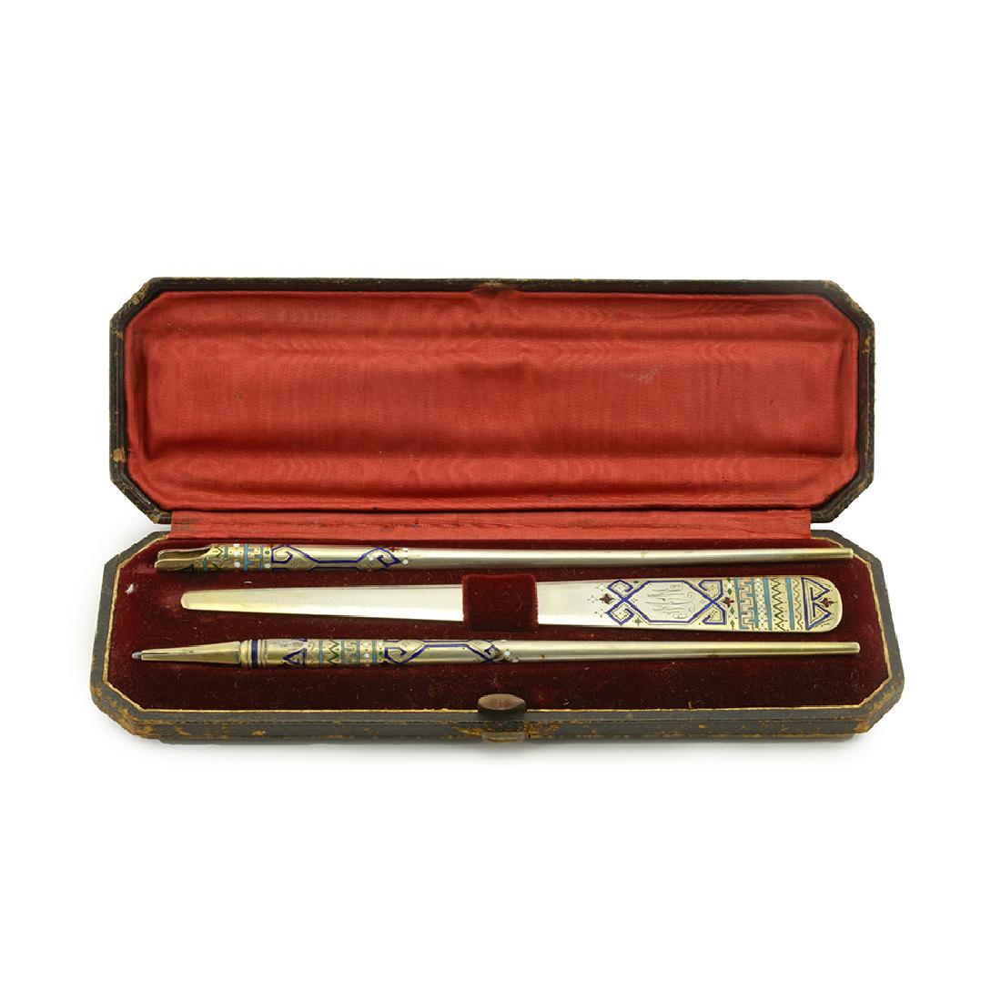 Russian silver enamel 3 piece cased desk set: A Russian silver gilt and champleve enamel 3 piece cased desk set consisting of a letter opener, pencil and pen. pencil length 7 1/2in. Bookmark length 7in.