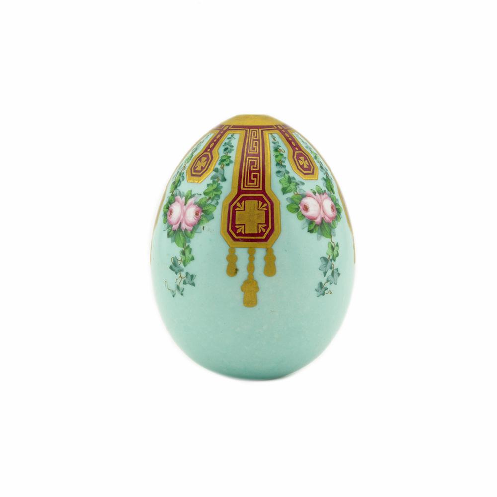 An Imperial Porcelain Factory Easter Egg: A Russian porcelain Easter egg, probably the Imperial Porcelain Factory, St. Petersburg, circa 1880. The robin's egg blue ground egg painted with garlands of roses and trailing ivy between gilt Neo-By