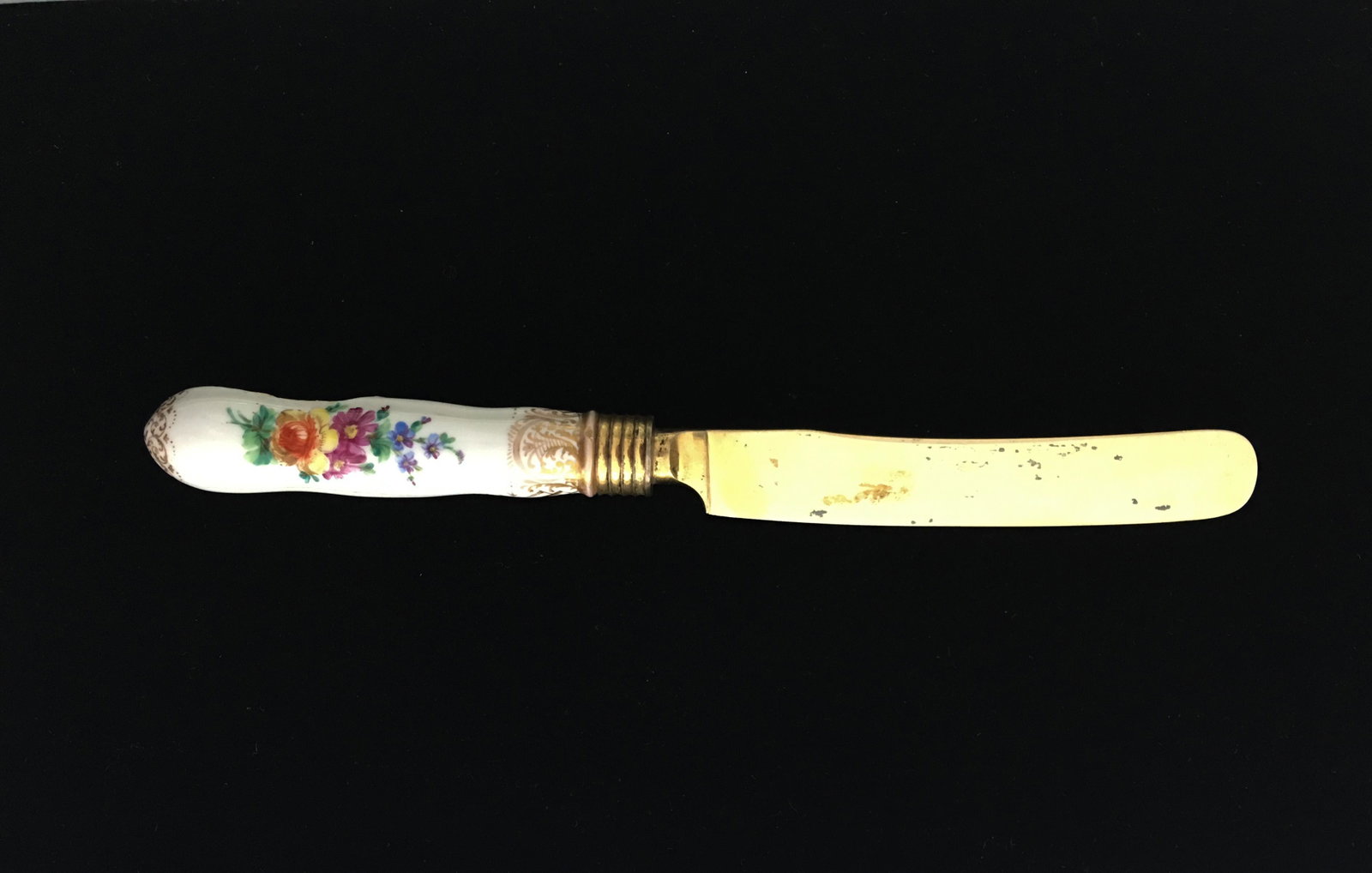 Catherine the Great Porcelain Knife: A Russian gilded silver and porcelain knife, Catherine the Great period. The handle decorated with floral sprays against a white ground. Length: 8 1/4 in. Condition: The handle is cracked and missing 