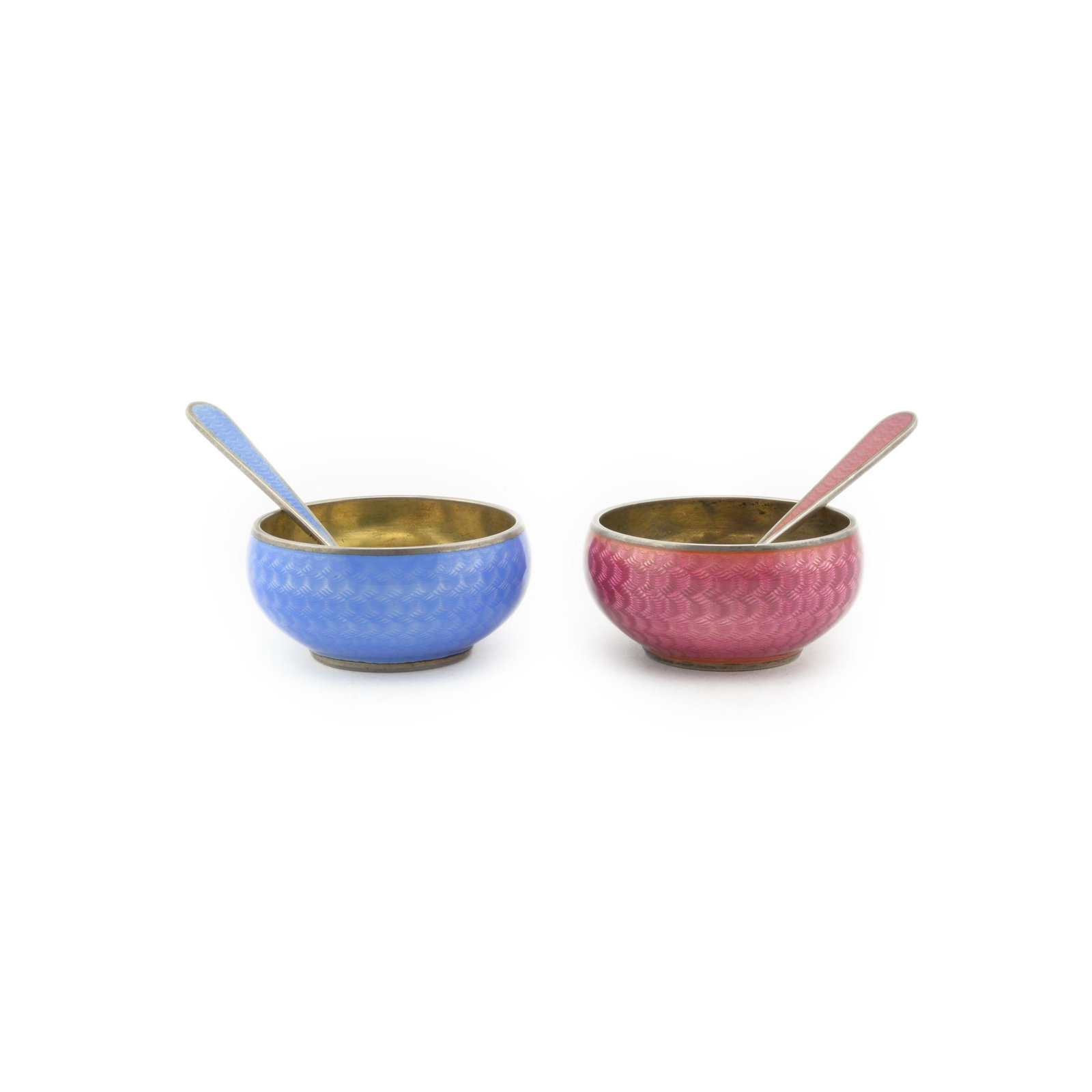 Pair of Grachev Enamel Salts: A pair of Russian silver gilt & guilloché enamel open salts with matching spoons, Grachev, St. Petersburg, circa 1899-1903. Of circular form, the exterior of the body enameled in a raspberry pink and