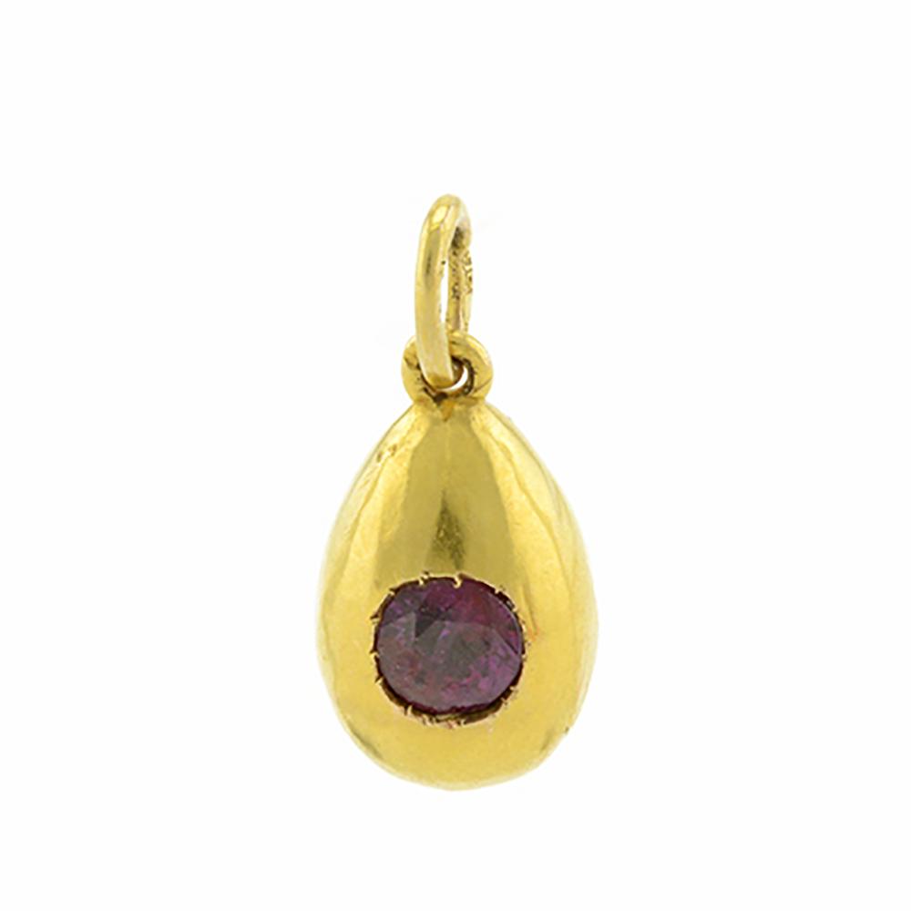 Russian gold & ruby miniature pendant egg by Karl Bok: An antique Russian gold & ruby miniature pendant egg, Karl Bok (or Bock), St. Petersburg, 1908-1917. The front of the polished body set with a large faceted ruby. Height including smaller suspension r