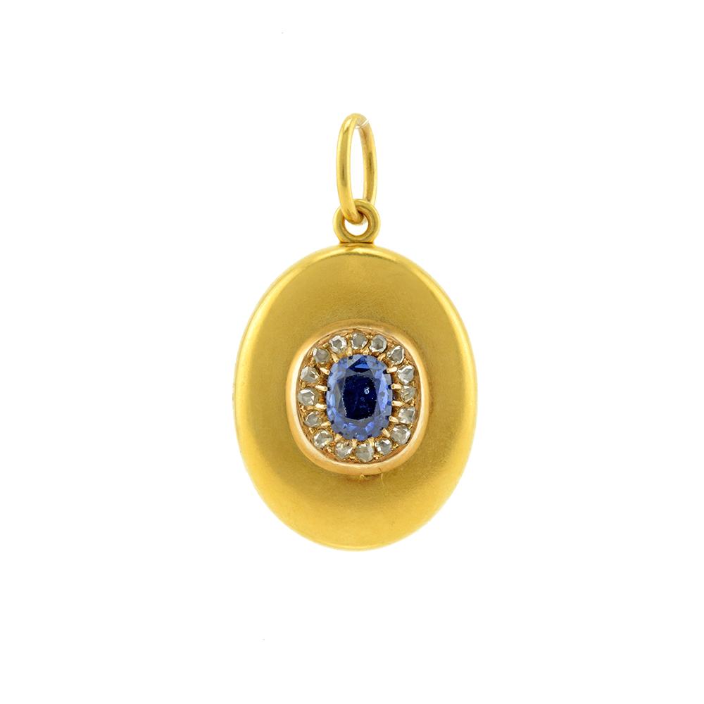 A Russian Gold, Sapphire and Diamond Locket: A Russian gold, sapphire and diamond locket, apparently unmarked. The front of the oval gold locket set with a large sapphire within a border of diamonds, opening to reveal two vacant compartments for