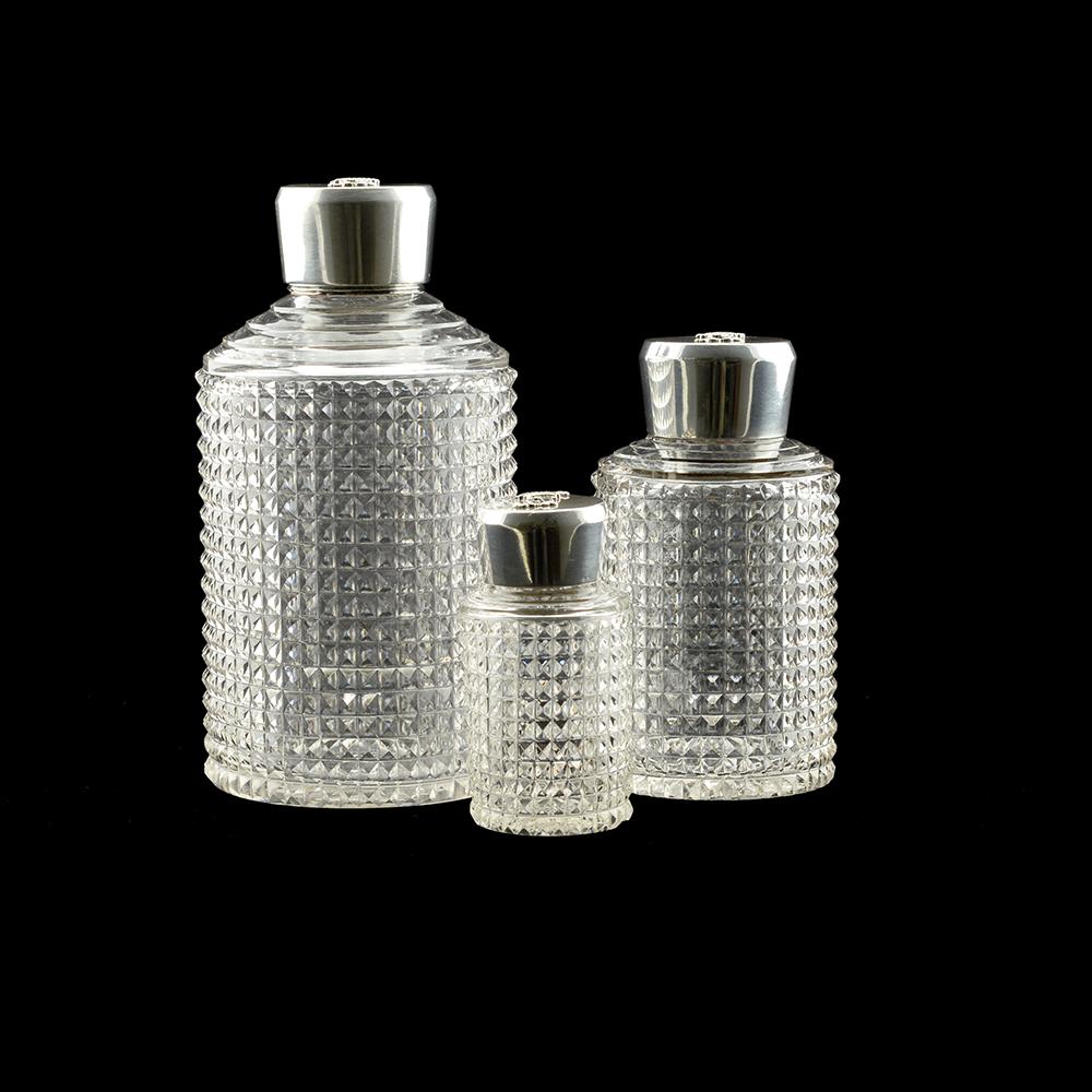 A set of 3 Russian silver mounted cut glass vanity jars: A set of 3 Russian silver mounted cut glass vanity jars with a N monogram underneath a crown on lids, apparently unmarked, but with French Import marks, circa 1886. These pieces were part of a larger
