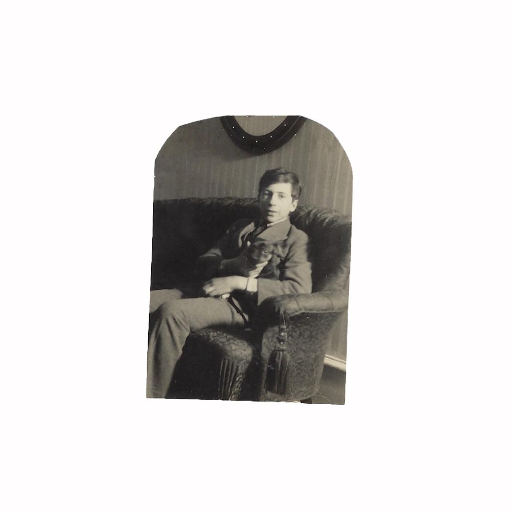 Photo of boy on couch holding a dog: Photo of boy on couch holding a dog (one of Grand Duchess Xeniaâ€™s grandsons?) Dimensions: 2 3/8 x 1 5/8 (6 x 4.1 cm)
