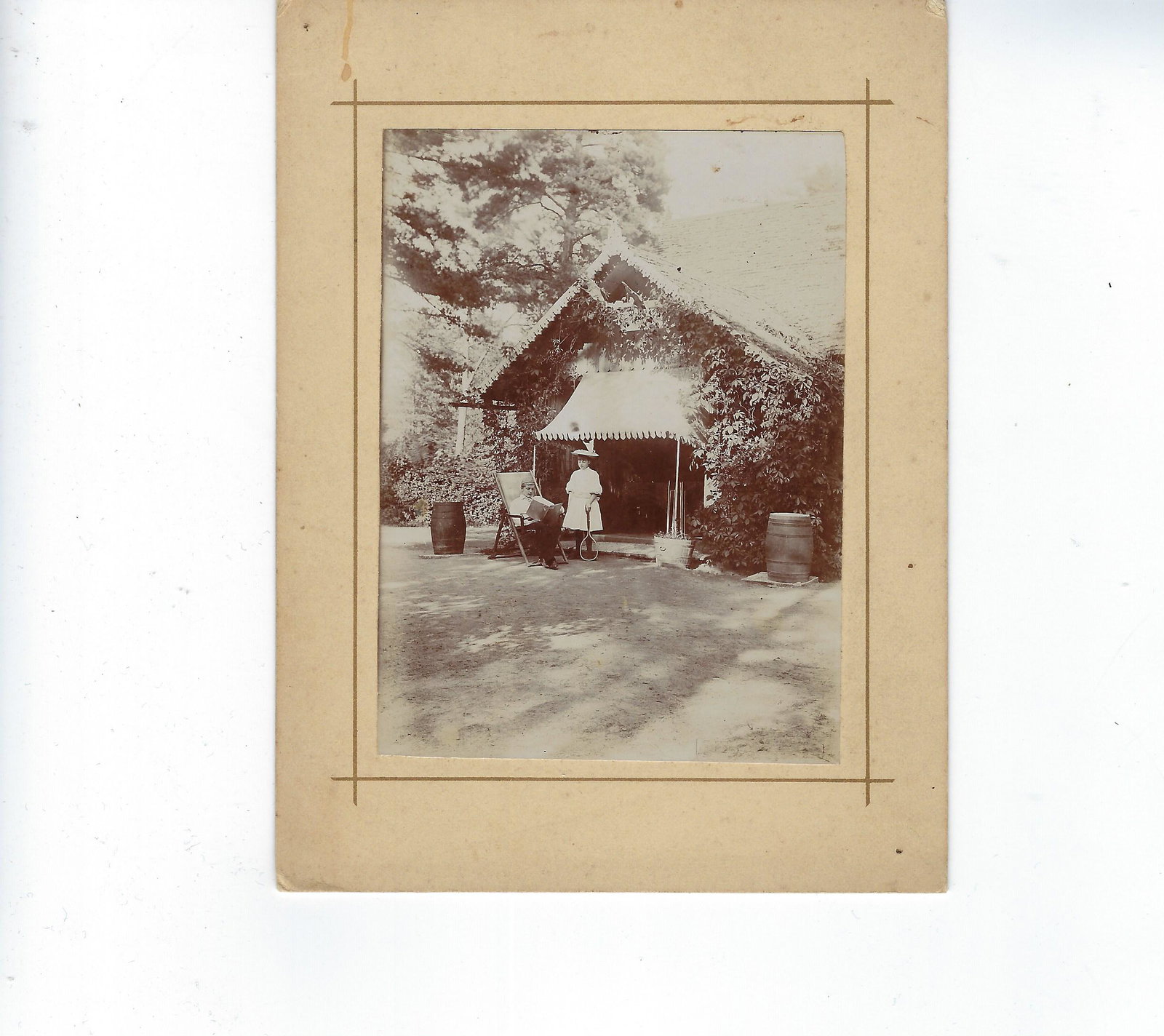 Photo of man & little girl in front of a wood cottage: Photo of man and little girl in front of a wood cottage Dimensions: Photo: 4 1/2 x 3 3/8 (11.4 x 8.5 cm)Mat: 6 3/8 x 4 6/8 (16.2 x 12 cm)