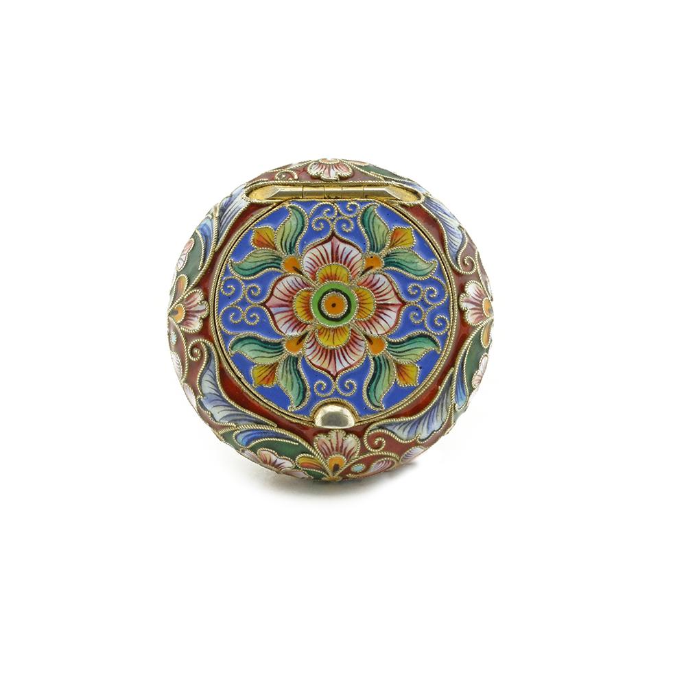 A Russian gilded silver and shaded cloisonné enamel pill box Ruckert: A Russian gilded silver and shaded cloisonné enamel snuff box or pastille case, Feodor Rückert, Moscow, circa 1899-1908. Of circular cushion form, the hinged lid decorated with scrolling mul