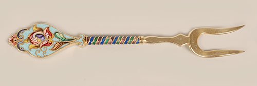 A Russian shaded cloisonne enamel fork Feodor Ruckert: A Russian gilded silver, shaded, and cloisonne enamel lemon fork, Feodor Ruckert, Moscow, circa 1908-1917. The shaped handle enameled with brightly colored stylized blooms against a turquoise blue gro