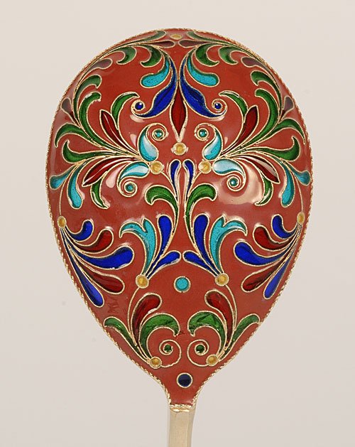 A Grachev cloisonné and plique-à-jour serving spoon: A Russian gilded silver, cloisonné, and plique-à-jour enamel serving spoon, Grachev Brothers, St Petersburg, circa 1890. The egg-shape bowl pierced with scrolling foliate motifs and decorated with p