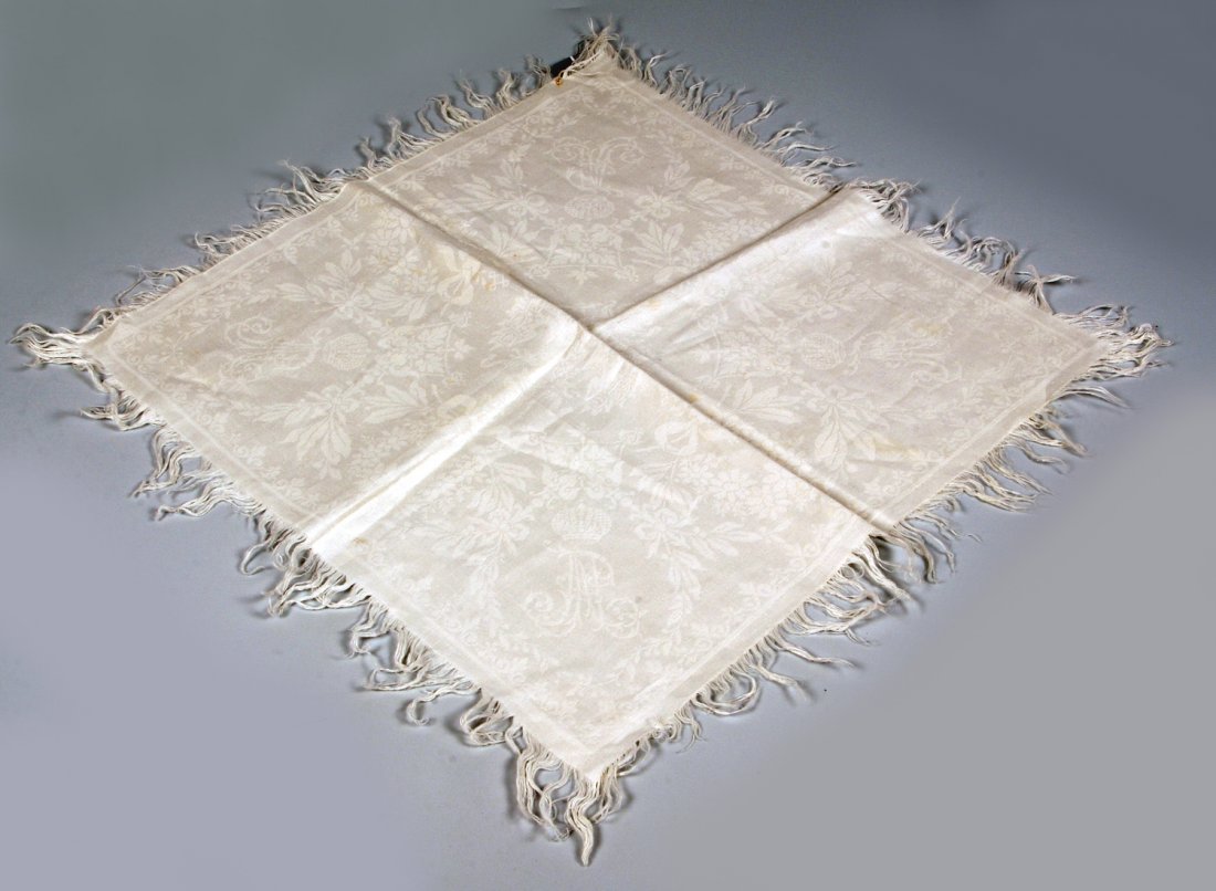 Grand Duke Pavel Alexandrovich: A Damask Napkin: The white damask napkin centered with the Imperial double-headed eagle with the Grand Duke's cypher in the four corners reserved against floral garlands, with fringed edges. Dimensions (without fringe