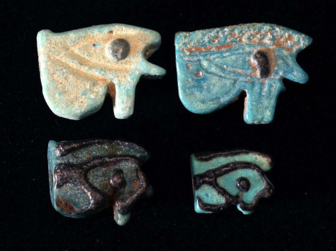 A Group of 4 Egyptian Faience Eyes of Horus: Egypt; Late Period, 716-30 Four wedjats of various sizes and colors. Dimensions largest: 5/16” (8 mm) " Provenance: The John J. Slocum Collection Mr. Slocum (1914-1997) collected most of his antiq