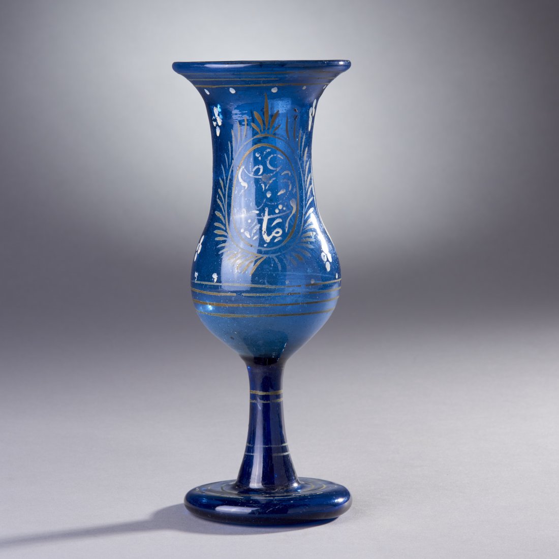 Blue Glass Near East Chalice: Possibly Turkish, ca. 18th-19th century. Blue glass chalice, pontiled base and remains of enamel decoration. Provenance: Old Connecticut Estate Height: 9.3 inches / 23.5 cm