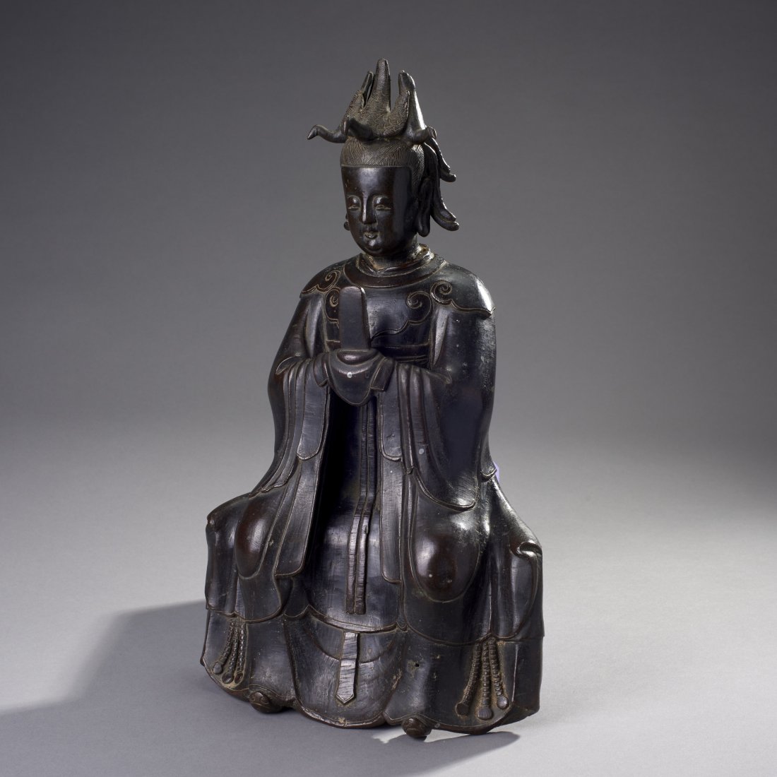 Large Chinese Bronze Seated Bodhisattva: China, ca. 16th-17th century. An imposing seated figure of Guanyin surmounted by three birds. Very nice details and deep patina. Base not included. Provenance: Old Connecticut estate. Height: 16 inche