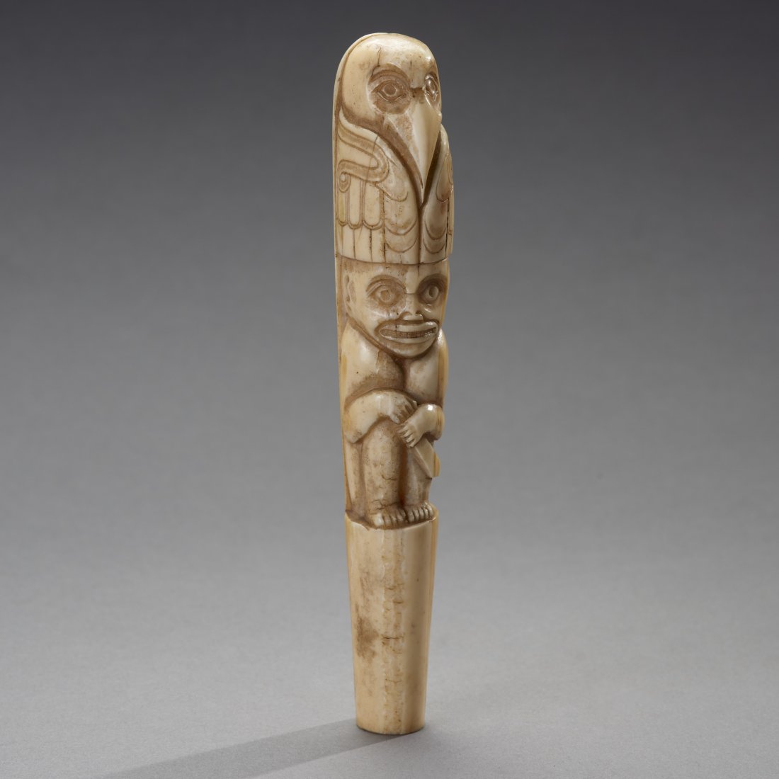 Northwest Coast Cane Handle: Native American, Northwest Coast, ca. 19th-early 20th century. Carved cane handle, taking the form of a totem raven perched on a shaman. Provenance: Old Connecticut estate. Height: 5.4 inches / 13.7 c