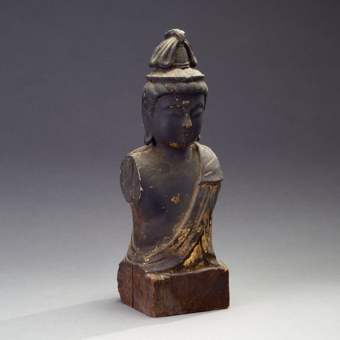 Wooden Japanese Figure of Kannon: Japan, ca. Edo Period or earlier. A sensitively-rendered, fragmentary wooden figure of Kannon, finely-carved and gilded, with much of the surface now covered with incense soot. Provenance: Old Connect