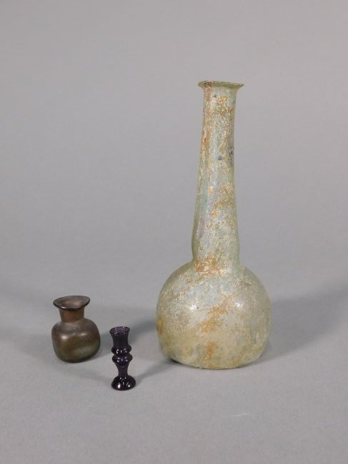 Three Pieces of Ancient Glass: Mediteranean, ca. ancient to modern. A tall Roman flask. A small vase with dimpled sides. A miniature chalice of undetermined age. Old Connecticut estate. Height of largest: 6.8 inches / 17.27 cm