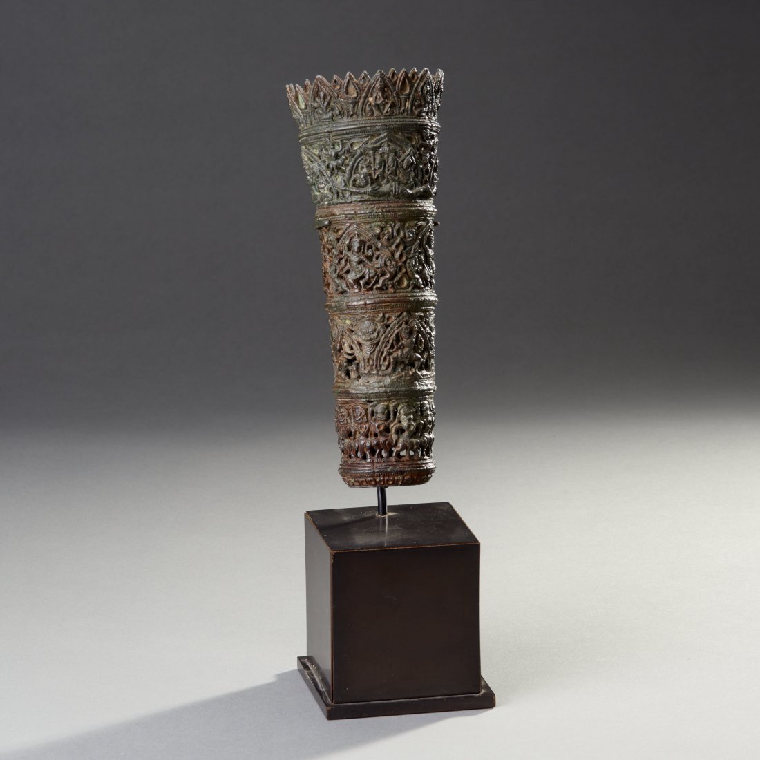 Rare Bronze Fly Whisk: Cambodia, Baphuon style. Ca. 11th-12th century. Very fine processional openwork chauri socket composed of cylindrical elements, the surface depicting numerous deities, animals, masks and adorants. Ext