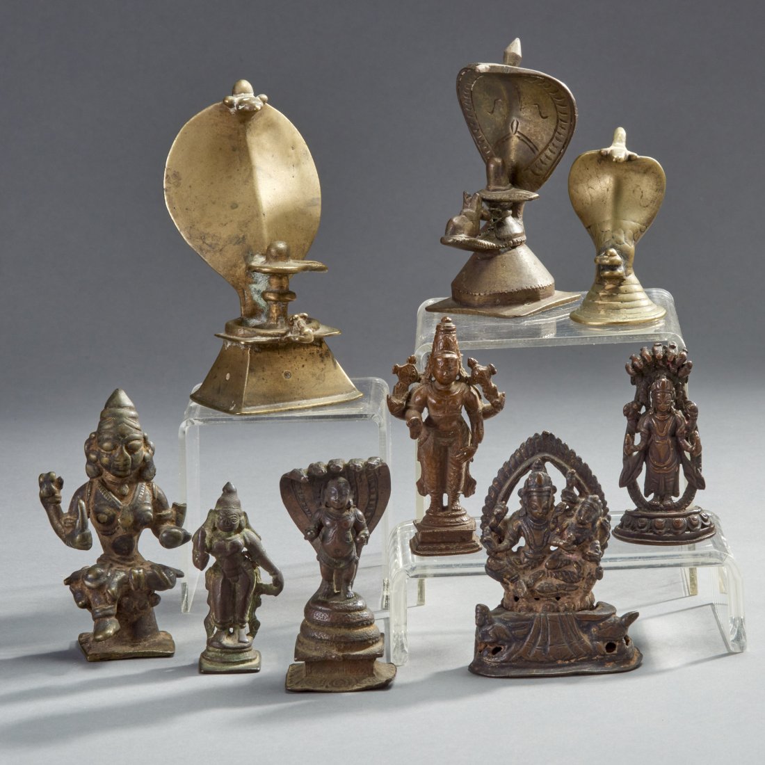 Nine Indian Bronzes: India and Nepal, ca. 18th-19th century. Nine bronzes. A nice assortment of various deities and including three Shiva Linghams. Height of largest: 4.8 inches / 12.1 cm