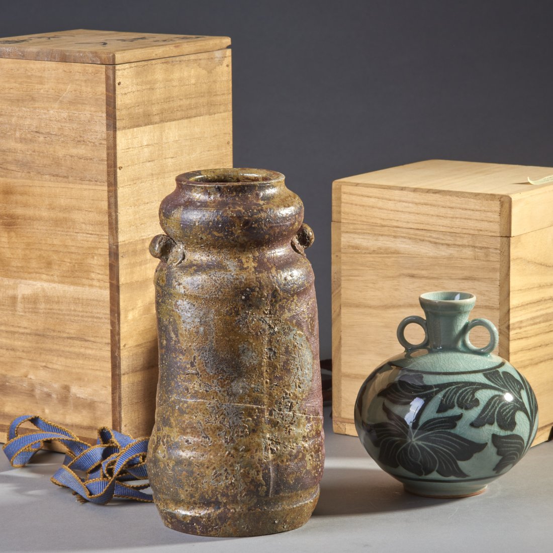 Two Japanese Bizen and Korean Celadon Vessels: Japan and Korea, ca. 19th and 20th century. Two ceramic vessels, the Bizen-ware flower vase apparently of good age, the Korean Celadon a modern example. Both with Japanese wood boxes. Height of talles