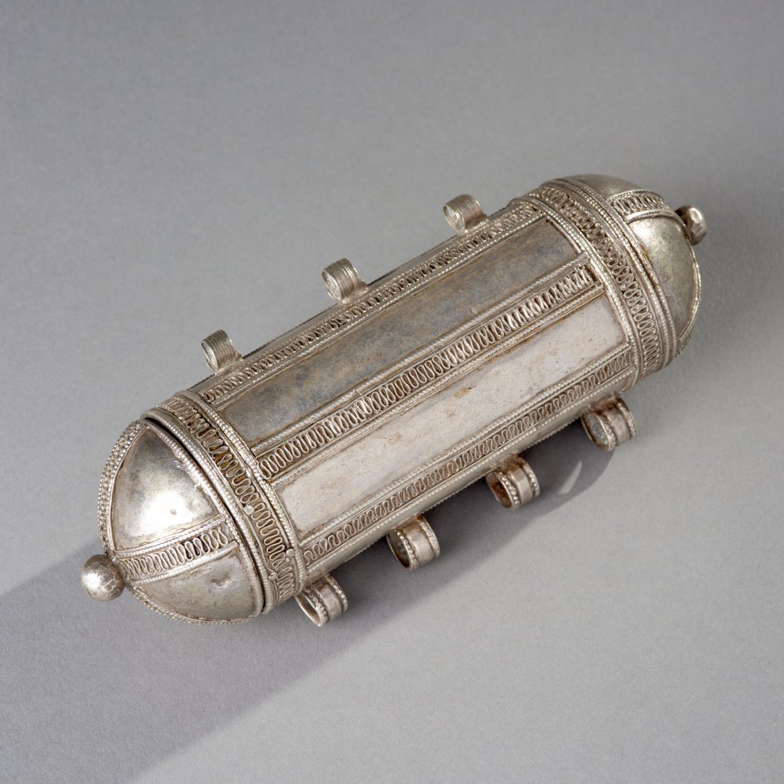 Omani Silver Koran Container with Koran: Omani silver Koran container with Koran, ca. 19th century. Length: 5.8 inches / 14.6 cm