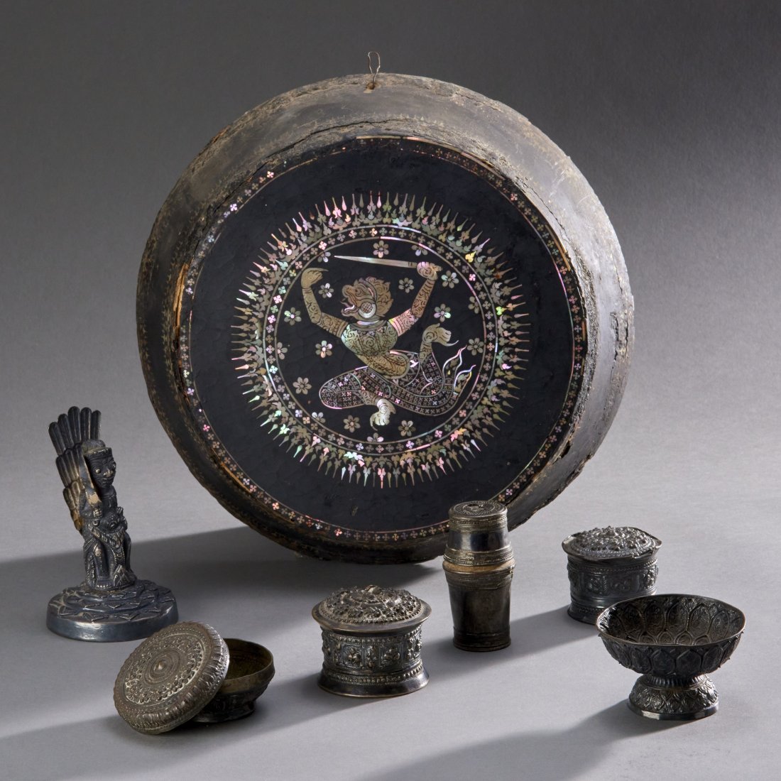 Seven Southeast Asian Mostly Silver Objects: Burma and Bali, ca. 19th century. Consisting of five silver betel nut-related containers, a charming silver figure of Garuda brandishing a sword, All will be quite nice after a desperately needed good