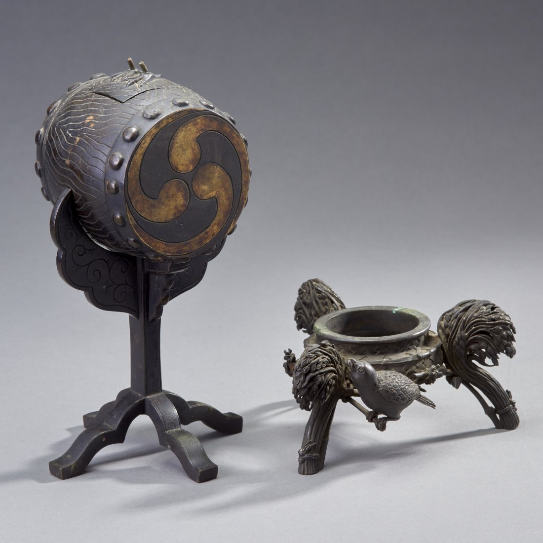 Two Japanese Bronze Objects: Japan, ca. Meiji Period. Two bronze objects. The first, a separately-cast ritual drum with lid on stand and retaining the feet of now missing bird. The second, an elaborate tripod stand for a vessel.