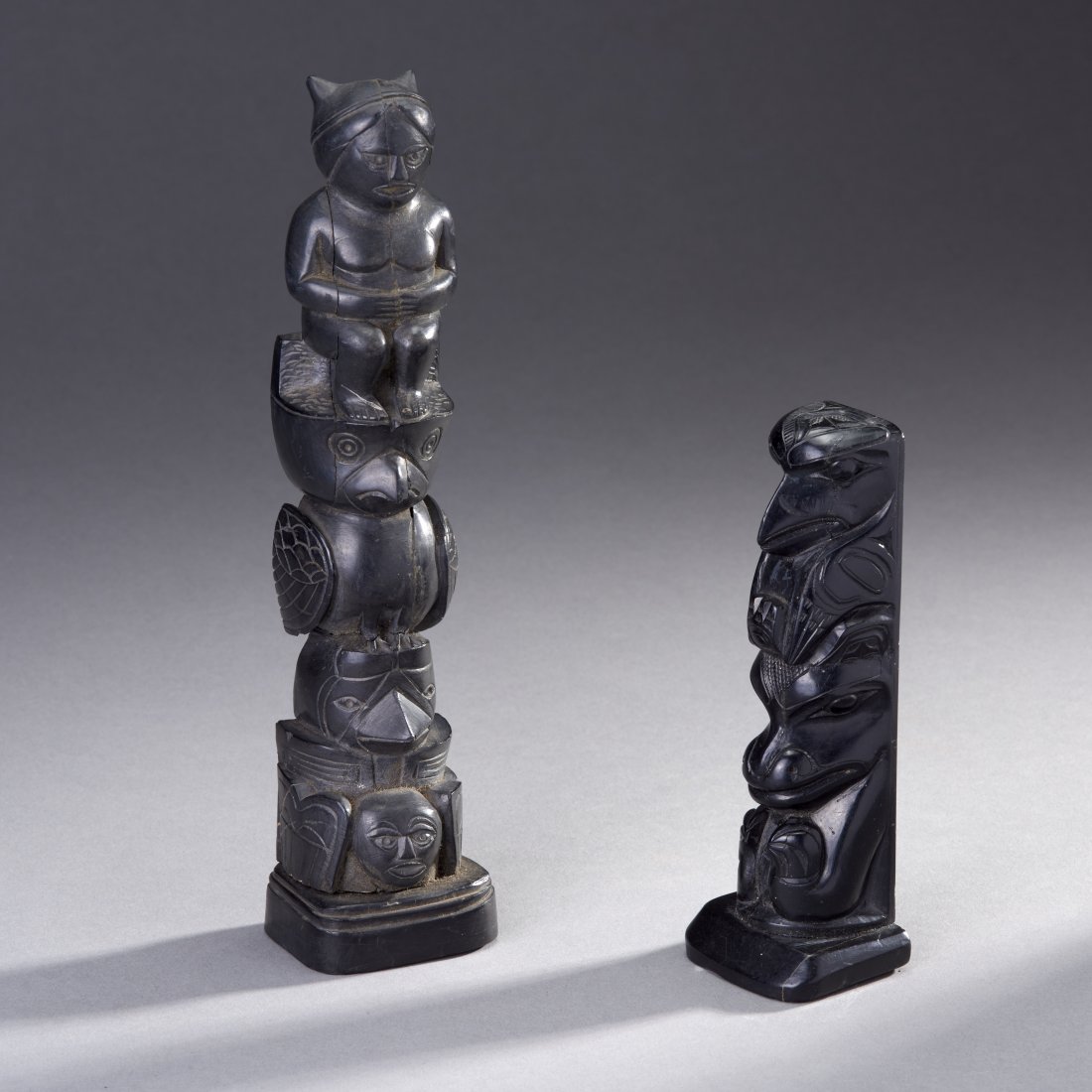 Two Northwest Coast Argillite Totems: Native American, Northwest Coast, ca. first half 20th century. Two argillite model totems. Old Connecticut Estate Height of tallest: 9 inches / 22.9 cm