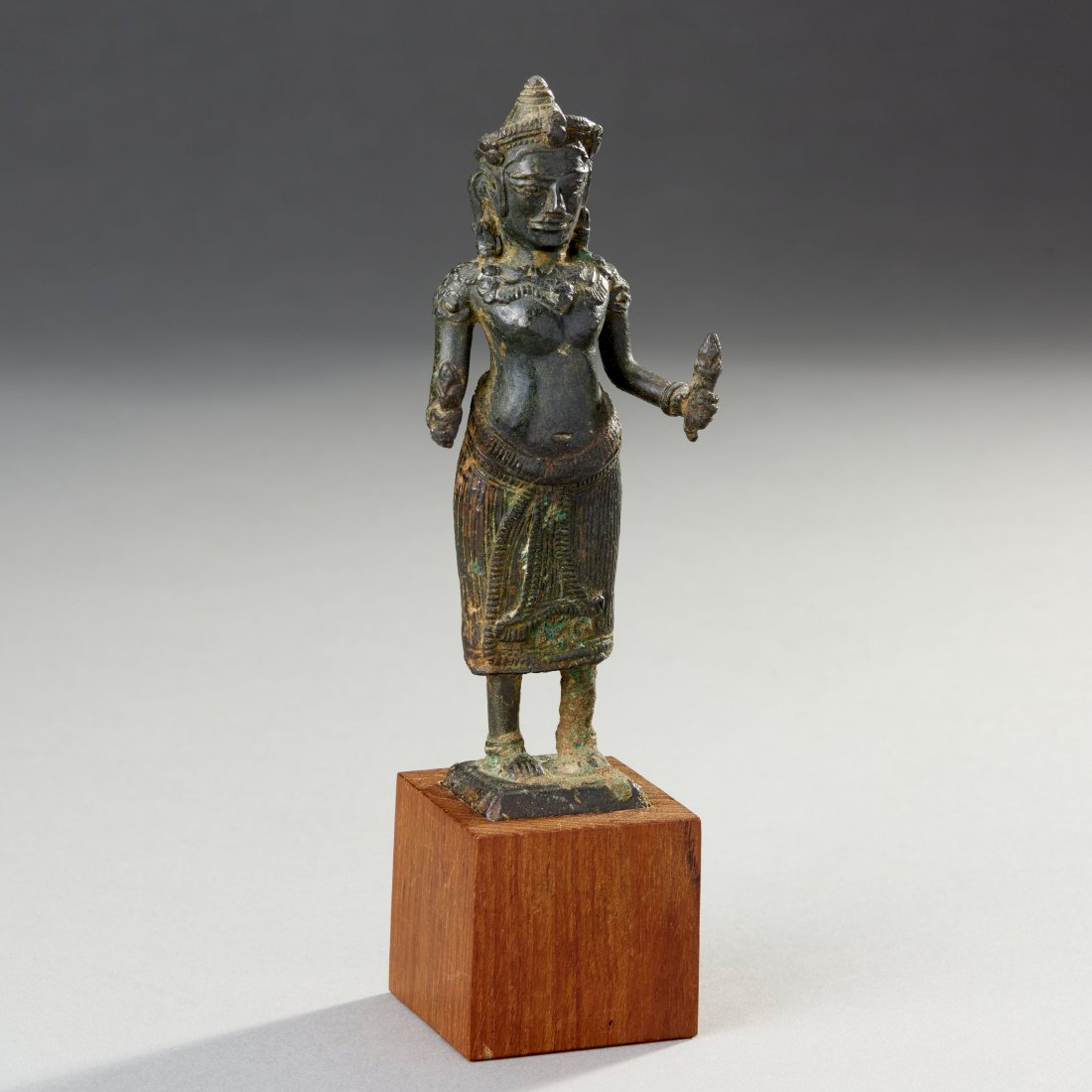 Fine Khmer Bronze Figure: Cambodia, ca. 12th century. A lovely figure of the goddess Uma with fine details and deep, almost black patina. It is possible that this is a silver alloy figure. Custom stand. Ex. Frank Caro, NYC. Mr