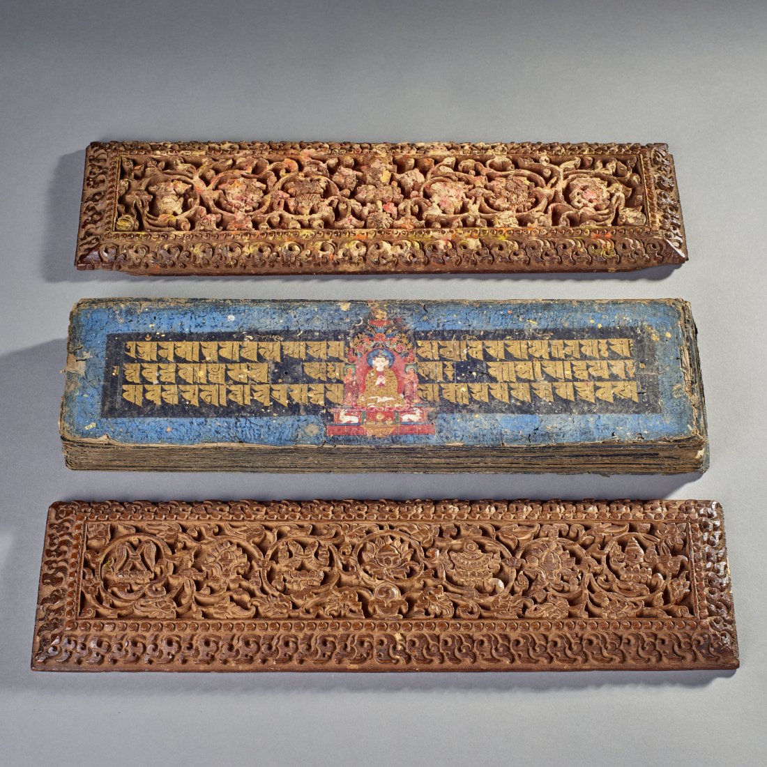 Rare Tibetan or Nepalese Sutra Book: Tibet or Nepal, ca. 18th century or earlier. Very rare. Sutra Book including its original wooden covers. Consisting of approximately 90 pages, each finely written in gold and silver ink on blue and bl