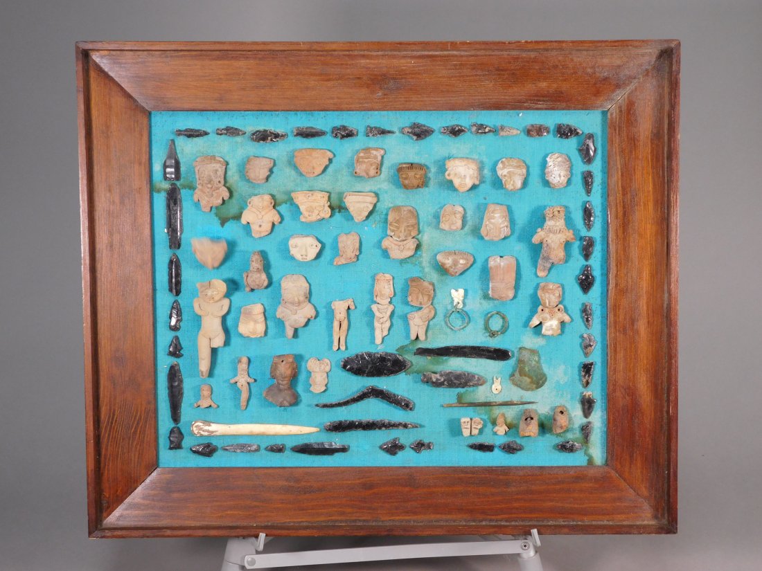Large Collection of Pre-Columbian Antiquities: Central America, ca. 1st millennium A.D. An interesting framed group of pottery figures, obsidian and bone tools, along with several small bronze objects. Frame size 24.75 x 20.5 inches / 62.87 x 52.0