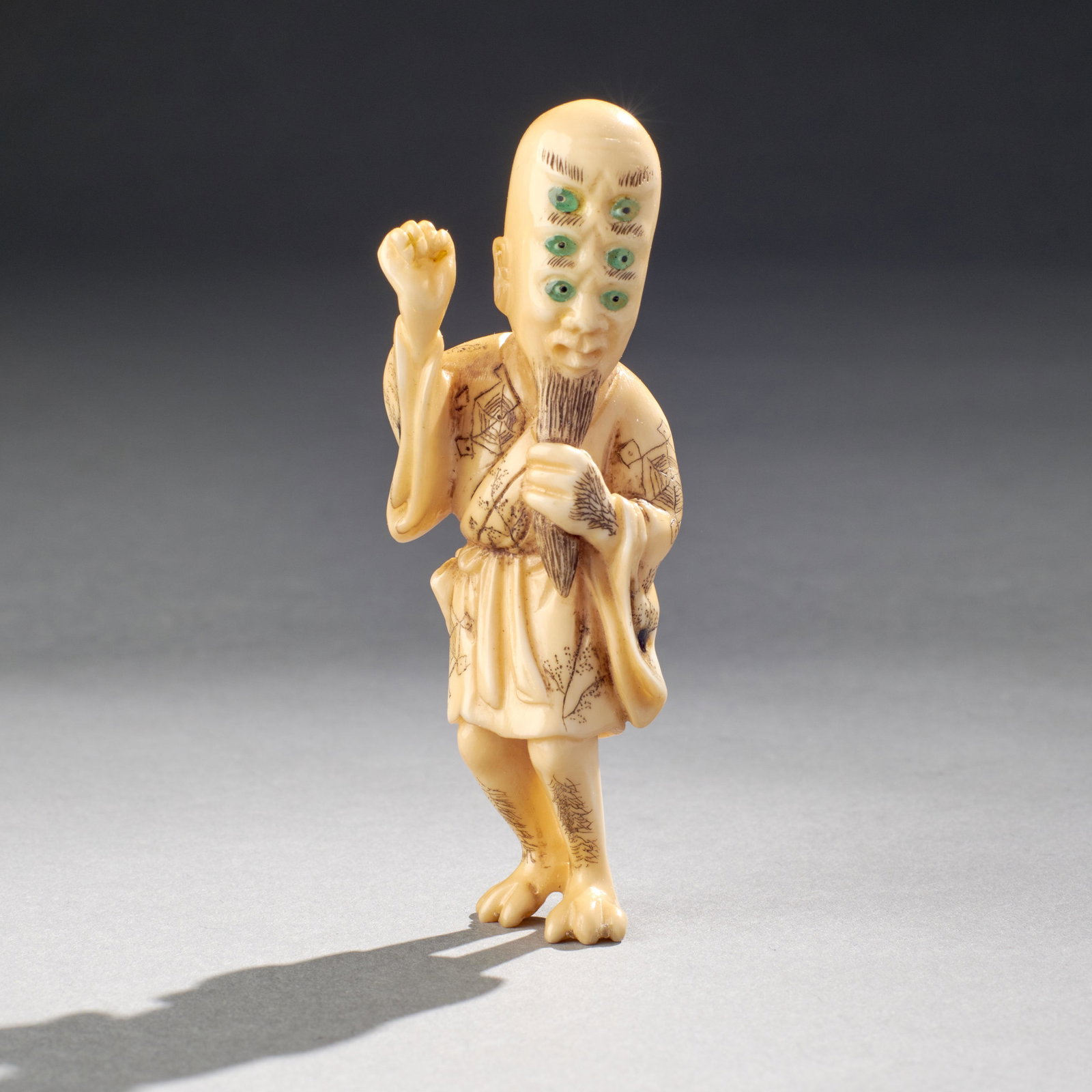 Carved Japanese Netsuke Of A 6-Eyed Demon: Carved Japanese netsuke of a 6-eyed demon, well carved and detailed, signed on pouch. Measures: 3 1/4" High (8.26cm) Important note: this lot CAN ONLY BE SHIPPED within the contiguous United States wi