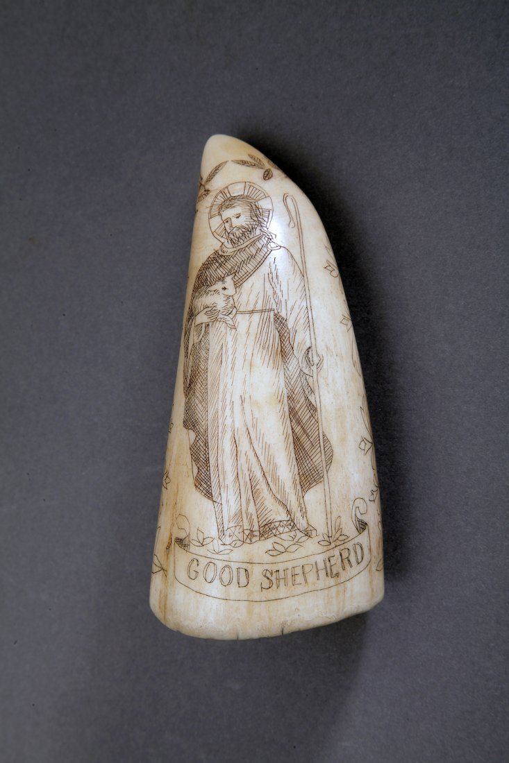 19th Century Religious Scrimshaw Whale Tooth: North America; 19th century. Sailor-made scrimshawed whale's tooth depicting the Annunciation and The Good Shepard, Jesus, and Mary. Dimensions Length: 4" (10 cm) Width: 2" (5 cm) Provenance Museum Ma