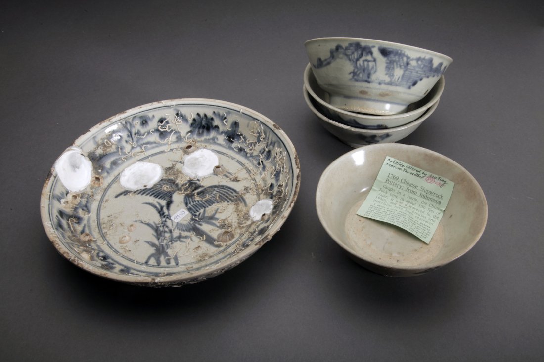 5 Antique Chinese Shipwreck Pottery Vessels: Indonesia; 18th century. Four similar small bowls of blue and white style. All with tags indicating they came from 1769 shipwreck. The larger example with bird in tondo.. Dimensions Largest Diameter: 